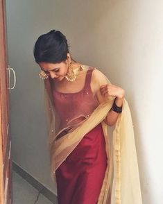 a woman in a red and beige sari