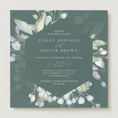 an elegant wedding card with greenery and leaves on the front, in dark green