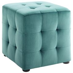 a blue square ottoman with wooden legs and buttons on the top, in front of a white background