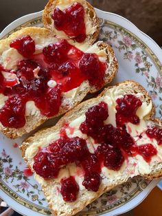 two pieces of bread with cranberry toppings on them sitting on a plate