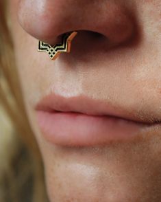 a close up of a person with a nose piercing on their left side of her face