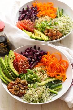 two white bowls filled with different types of vegetables