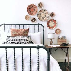 a bedroom with plates on the wall above the bed