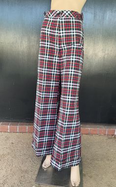 1970s Tomboy of California flare leg pants. White, red and blue cotton. Decorative buckles on sides on waist. Nylon zip front. One button fastener on waistband. Cuffed hems. Size 7 Measurements  26" waist 34" hips 43" length 32" inseam 30" hem sweep each leg Dashing pants show beautifully exhibiting no wear. Deadstock item having never been worn. Retro Red Bottoms For Fall, Red Retro Full-length Pants, Retro Full-length Red Pants, Red Full Length Retro Pants, Retro Red Full Length Pants, Retro Red Trousers, Retro Cotton Wide Leg Full Length Pants, Retro Full-length Cotton Pants, Retro Red Cotton Pants