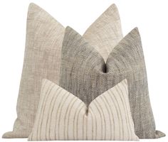 two pillows with different patterns on them, one in grey and the other in beige