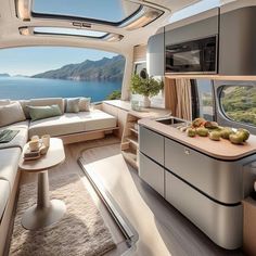 the interior of a boat with an open kitchen and living room area on one side