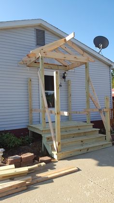 a small house with a porch and wooden steps