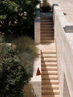 stairs leading up to the top of a building with trees in the backround