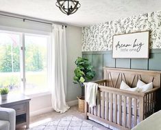 a baby's room with a crib in the corner and a large window