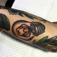 a man's arm with a light bulb tattoo on it