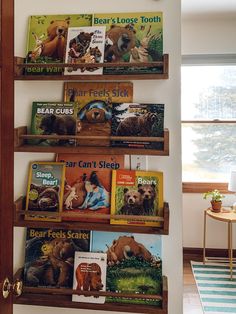 there are many books on the shelves in this room and one is for children to read