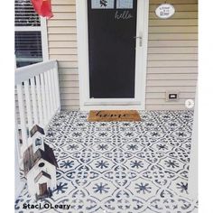 the front porch is decorated with blue and white tiles