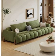 a living room with a green couch and white rug