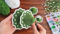 someone is making crocheted broccoli flowers out of small pieces of yarn