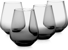 four wine glasses sitting next to each other