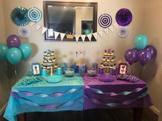 the table is set up with purple, blue and green desserts for a little mermaid birthday party