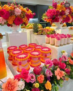 colorful flowers and candles are on display at a wedding or bridals event with pineapple juice in the foreground