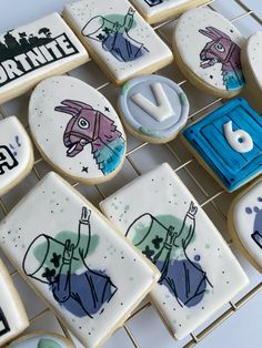 decorated cookies are arranged on a cooling rack