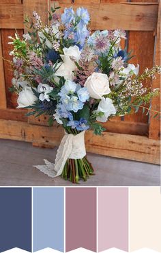 a bouquet of blue and white flowers in front of a wooden door with lace on it