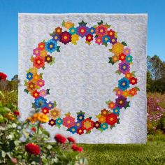 a white quilt with colorful flowers on it