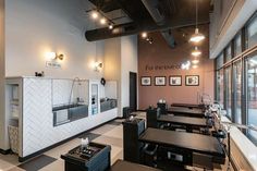 the interior of a restaurant with tables and chairs