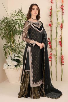 Black is a color which attracts every person. this long silhouette is well embellished with kora, beads, dabka ,pearls, sequence sittara work on neckline with velvet applique to enhance the beauty of hand work, its created with statement loop design on neckline, tassels on chawk paired with gharara which is bottom frilled with jamawar & kamdani dupatta is always a best pick. Shirt Fabric: pure jamawar Shirt Length: 48” Gharara Fabric: jamawar Dupatta Fabric: khadi net kamdani Shirt & Dupatta Col Back Neck Designs For Suits, Jamawar Dresses, Kamdani Dupatta, Black Gharara, Jamawar Gharara, Red Gharara, Shadi Outfits, Gharara Pakistani, Net Dress Design