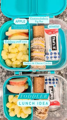 two plastic lunch boxes filled with food on top of a granite countertop next to each other