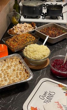 an assortment of baked goods on a kitchen counter with dishes and utensils in front of them