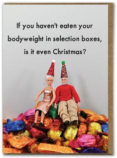 two dolls sitting on top of a pile of foil wrapped presents with the caption if you haven't eaten your bodyweight in selection boxes, is it even christmas?