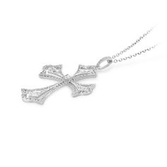 Faith meets fashion in this stylish diamond pave cutout cross pendant. Created in 18K white gold, this design features a polished diamond embellished scalloped-edged cross with a brilliant cut round sparkling diamond tying the design together.  A fashionable look she'll adore and wear daily as well as on special occasions. The perfect gift for an anniversary. 
0.65 carat pave setting
18k white gold
We offer a Free virtual Consultation from the comfort of your home so that you can Cross-shaped Diamond Necklace With Single Cut Diamonds, Diamond White Cross Pendant Necklace In Cubic Zirconia, Diamond White Cubic Zirconia Cross Pendant Necklace, Formal Diamond Cut Cross Pendant Necklace, Elegant Sterling Silver Cross Necklace For Formal Occasions, Diamond White Cross Pendant Necklace With Brilliant Cut, Elegant Diamond White Cross Pendant Necklace, Silver Cross Jewelry With Brilliant Cut, Silver Brilliant Cut Cross Pendant Jewelry