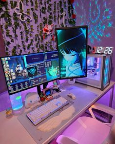 two computer monitors sitting on top of a desk next to a keyboard, mouse and monitor