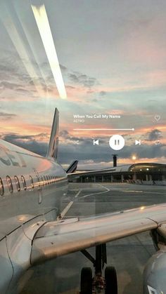 an airplane sitting on the tarmac at sunset