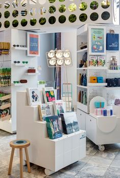 the inside of a store with many items on display and lights hanging from the ceiling