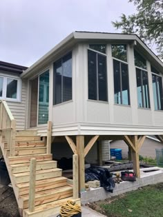 a house that is under construction with some stairs leading up to the front door and second story