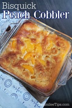 a casserole dish with peach cobbler in it on a blue and white tablecloth