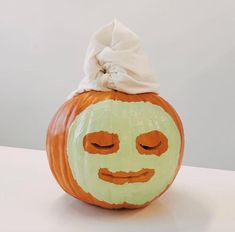 a pumpkin with a face painted on it