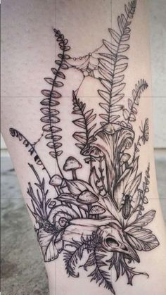 a woman's leg with plants and mushrooms on it