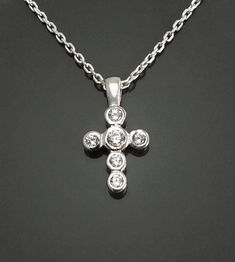 This Cross Necklace is handmade with sterling silver, and set with Lab Diamonds Simulant. Average silver weight: 1.2 gr. ► PRODUCTION METHOD:  💓 Handmade with Love and Care - Because it's better that way 💓 ► MATERIALS: * Diamond CZ Gemstone, cut and faceted for the highest quality standards to achieve maximum brilliance, in a timeless outline setting. * High Quality High Quality Solid 925 Sterling Silver Dimensions : 2.0 cm X 1.0 cm Although Lab diamonds are not natural diamonds, they sparkle Catholic Crucifix, Sterling Silver Cross Necklace, Diamond Simulant, Small Crosses, Cross Jewelry, Necklace Sterling Silver, Stone Pendant, Cz Stone, Lab Diamonds