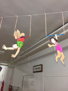 two children are hanging upside down from the ceiling