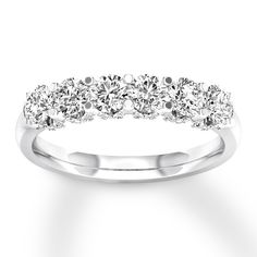 a white gold wedding ring with five diamonds