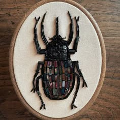 a close up of a bug on a wooden surface