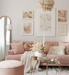 a living room with pink couches and pictures on the wall above them, along with a coffee table