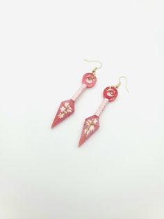 "Beautiful Kunai Earrings with Cherry Blossom accents and ribbon wrapped handles. Will take your cosplay up a notch. Anime lovers will love them. About 2\" long. Can be made in other colors just message me. Earrings are on gold tone hypoallergenic wires." Japanese Earrings, Earrings Anime, Cherry Blossom Earrings, Earrings Japanese, Anime Earrings, Your Cosplay, Dangle Hoop Earrings, Earring Wires, Ribbon Wrap