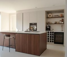 a kitchen with an island and bar stools