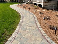 a brick walkway in front of a house