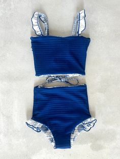 This darling tankini is basically four swimsuits in one (see the variations below). In our opinion, it is as cute as swimsuits come. We tested the fabrics in the salty ocean, sandy beaches, pools, and hot-tubs. It is high-quality, comfortable, and SO much fun!! Truly, a combination you won't want to live (or swim) without ;). Mid-waisted reversible bottoms Leg ruffle on size 6 only (picture below) Adjustable top with tie-string back High-quality textured fabric with cutest seashell print Full Co Cute Tankinis, Clothes Preppy, Floral Swimwear, Beach Clothes, Swimming Suits, Preppy Clothes, Reversible Top, Embroidered Shoes