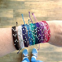 a woman's arm with several bracelets on it