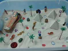 a sand tray filled with different types of toys