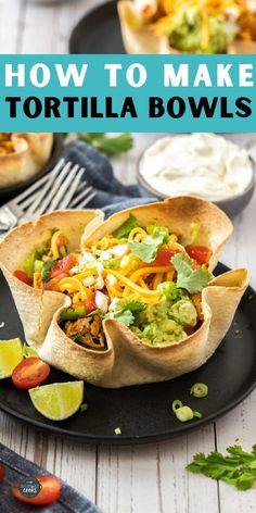 tortilla bowls on a black plate with limes and cilantro in the background