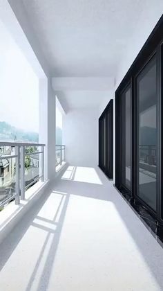 an empty balcony with lots of windows and balconies on both sides, overlooking the city